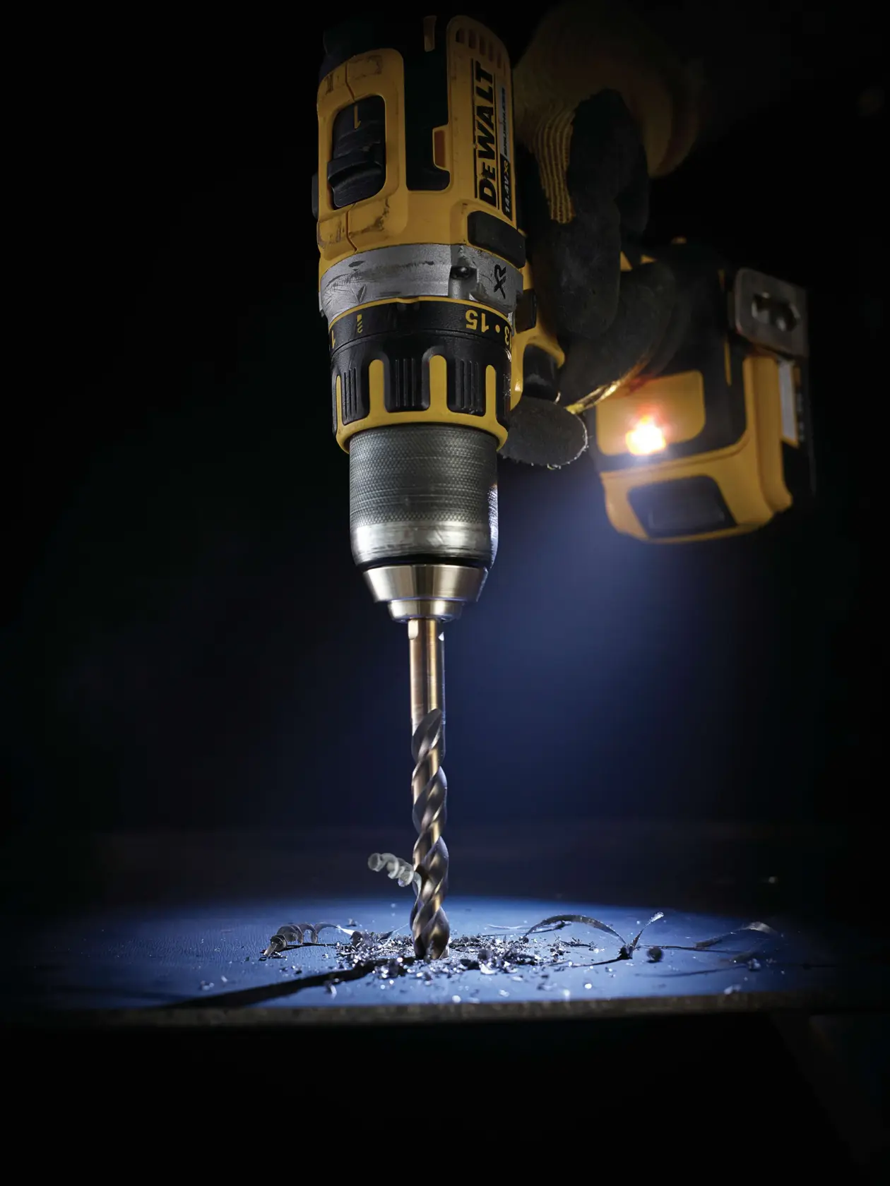 DEWALT drill in use with DT5058, DT5058-QZ SKUs, drilling metal surface. Photography product category.