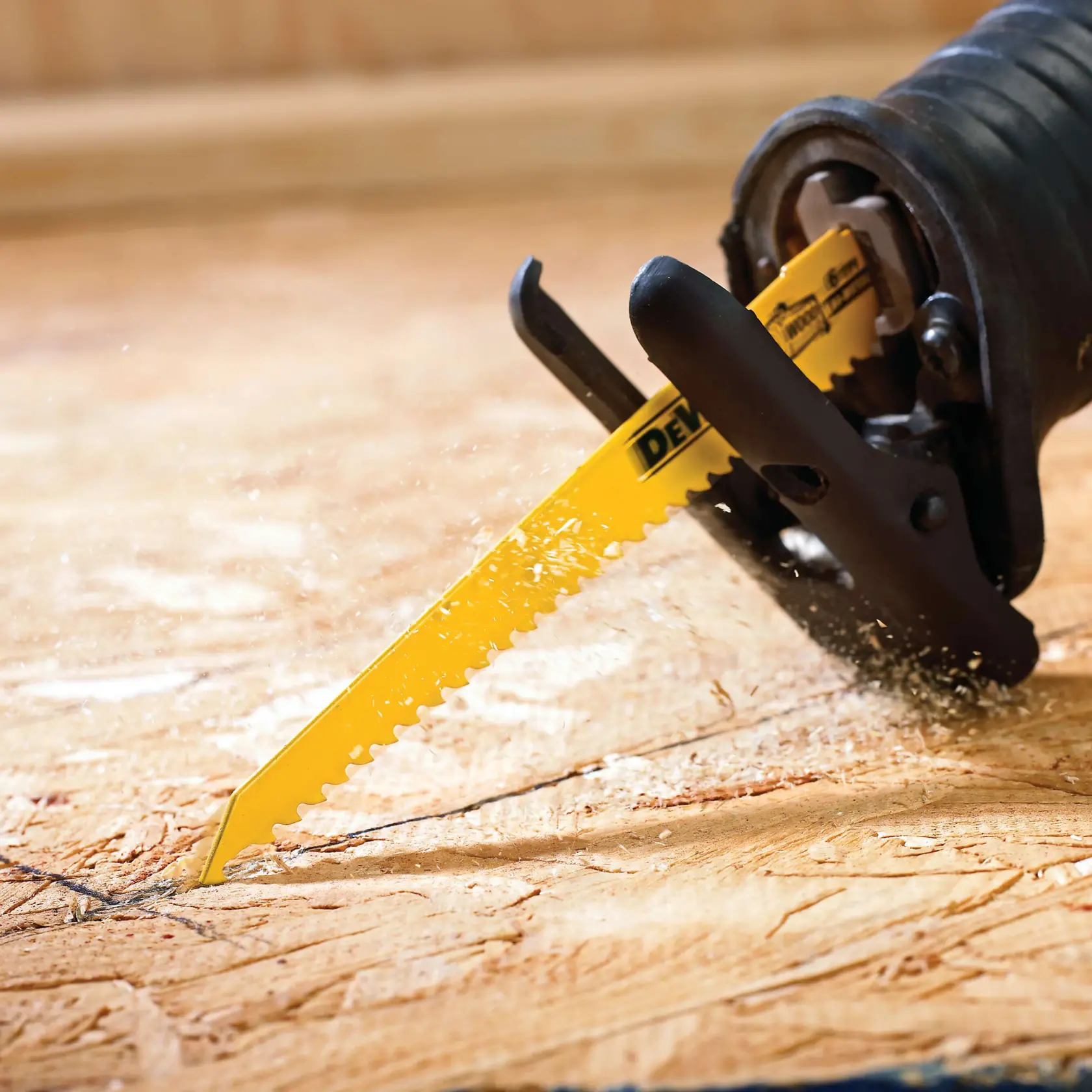 A DEWALT reciprocating saw blade set with nine yellow blades of varying lengths arranged in a row, next to a transparent plastic storage case with the DEWALT logo.