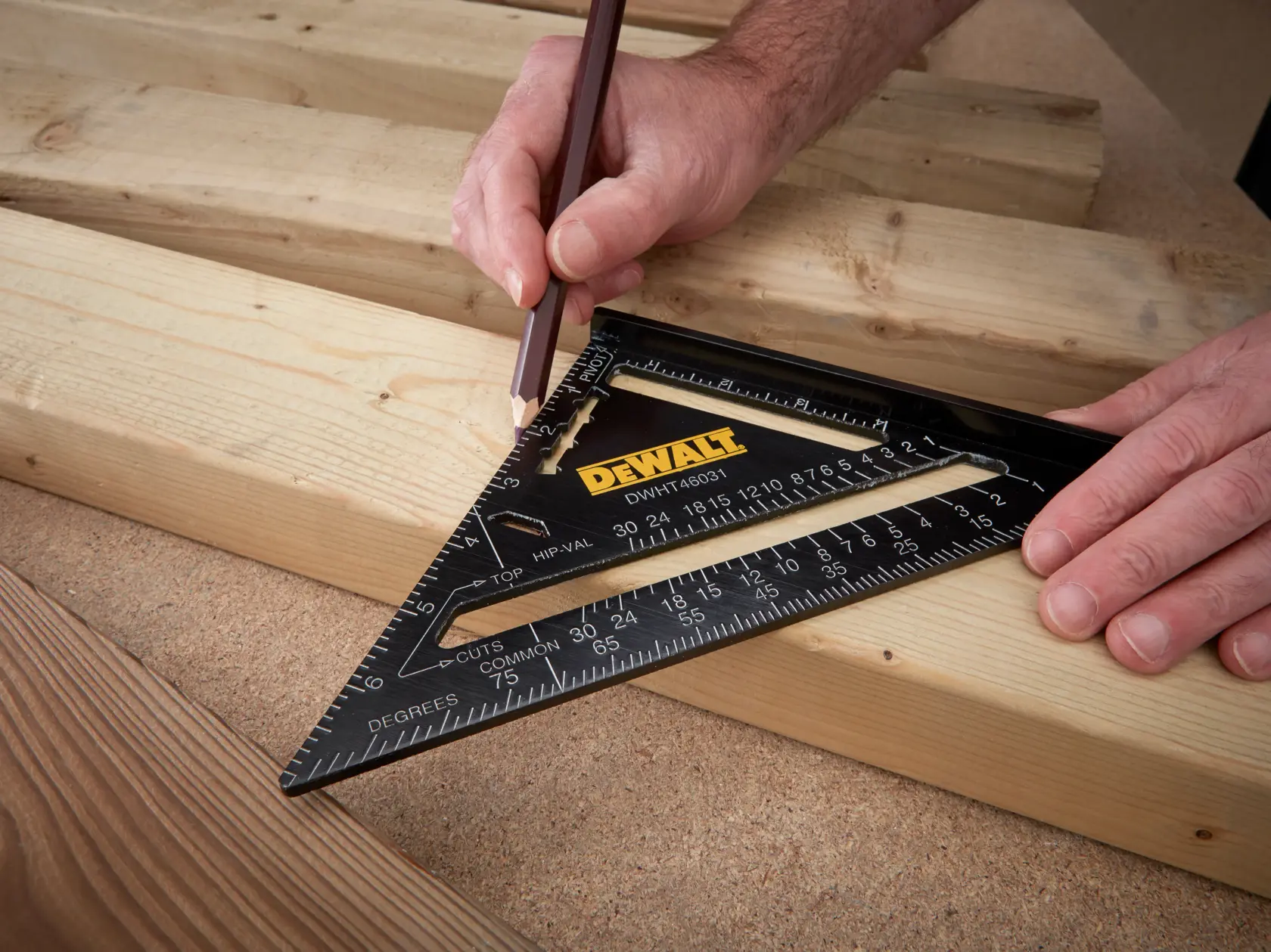 A black plastic or metal carpenter's square, also known as a speed square or rafter square. It has measurement markings along the edges, a slot in the middle, and a printed chart for common rafter conversions, showing inch rise per foot and corresponding degrees. Used for marking, measuring, and guiding cuts in woodworking and construction.